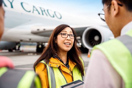 May So and colleagues on tarmac with Cathay aircraft