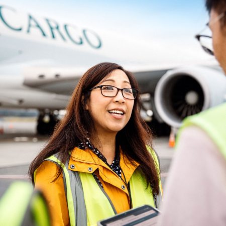 May So and colleagues on tarmac with Cathay aircraft