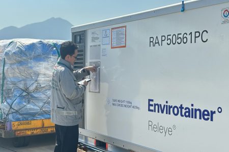Crew member checking labels on envirotainer releye ULD