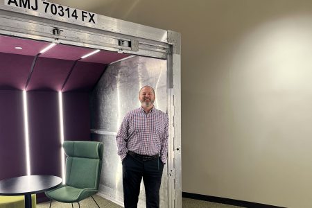 Jeff Euler standing in front of ULD with table and chair inside