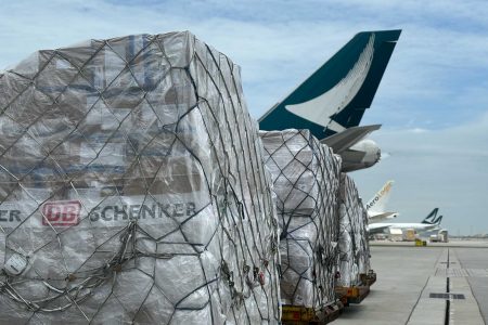 Cargo with DB logo in front of Cathay's plane