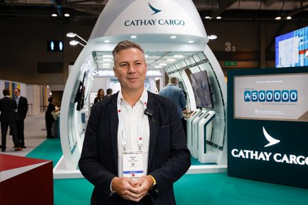 Cathay General Manager, Brand, Insights and Marketing Communications, Edward Bell in front of the Cathay cargo stand
