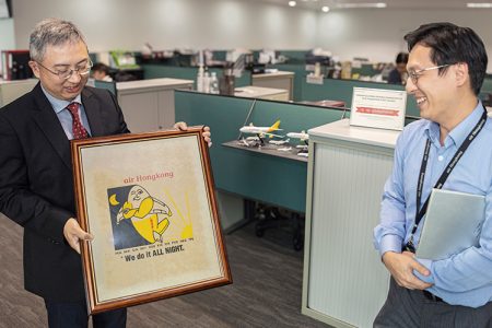 Clarence Tai admires some old advertising for Air Hong Kong with Head of Business Development and Services Ricky Yeung