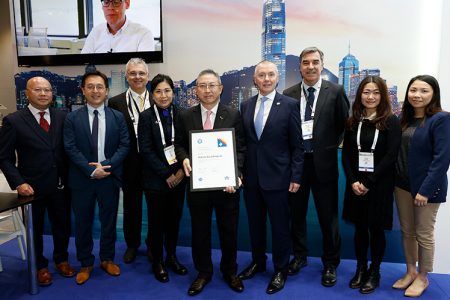 Clarence Tai, Chief Operating Officer at Air Hong Kong (centre) collects the membership certificate from IATA Director General Willie Walsh