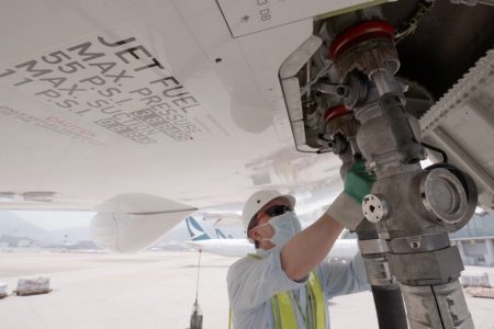 A person working on refueling an airplane