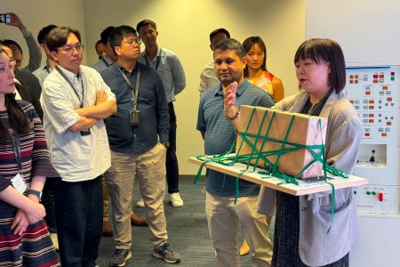 Learning Manager Cargo Services Sherriel Yu shows off her old shoebox training aid at the opening of the VR CAVE
