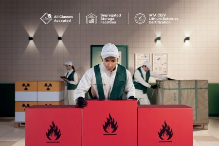 Three warehouse workers handling hazardous goods including flammable and radioactive materials, with icons highlighting Cathay Cargo’s acceptance of all classes, segregated storage, and IATA CEIV lithium battery certification.