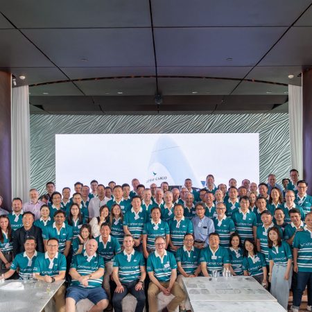 Cathay Cargo customers and staff gather for a group picture in their rugby tops at the Cathay Cargo Business Update