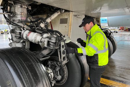 Chung checks the brakes on a newly arrived Cathay Cargo freighter