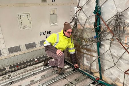 CSO Colin Romberg checks the locks on the main deck hold ahead of the aircraft’s onward leg