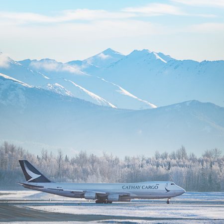 A Cathay Cargo Boeing 747-8F freighter lines up for a snowy take-off at Ted Stevens Anchorage International Airport
