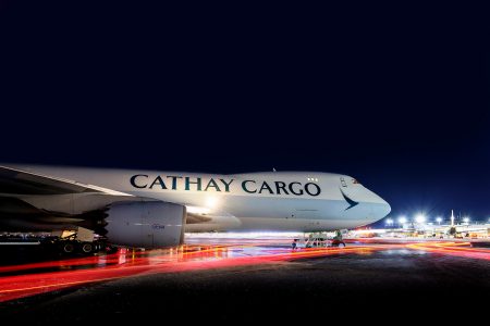 A Cathay Cargo freighter under the northern lights undergoing its turn at Anchorage