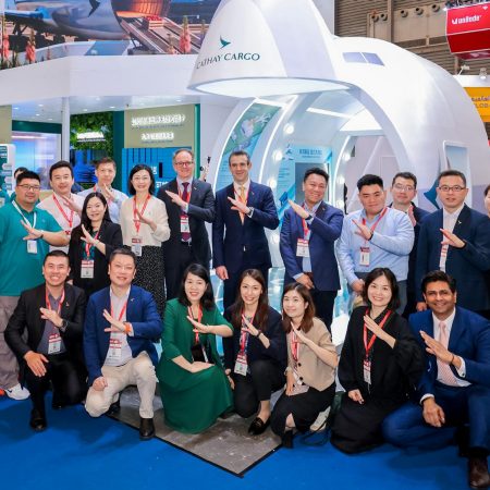 The Cathay Cargo team poses in front of their exhibition stand at the Air Cargo Shanghai event