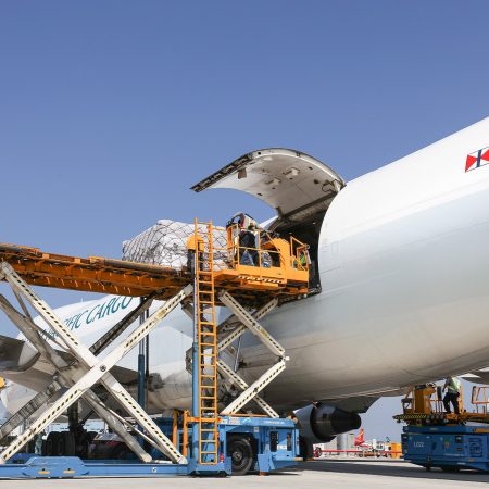 A Cathay Cargo Boeing 747 freighter loading cargo through its rear door at Hong Kong International Airport
