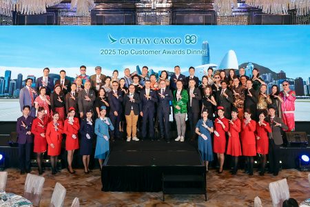 The Cathay Cargo senior team and guests pose with cabin crew dressed in heritage uniforms at the 2025 Top Customer Awards Dinner